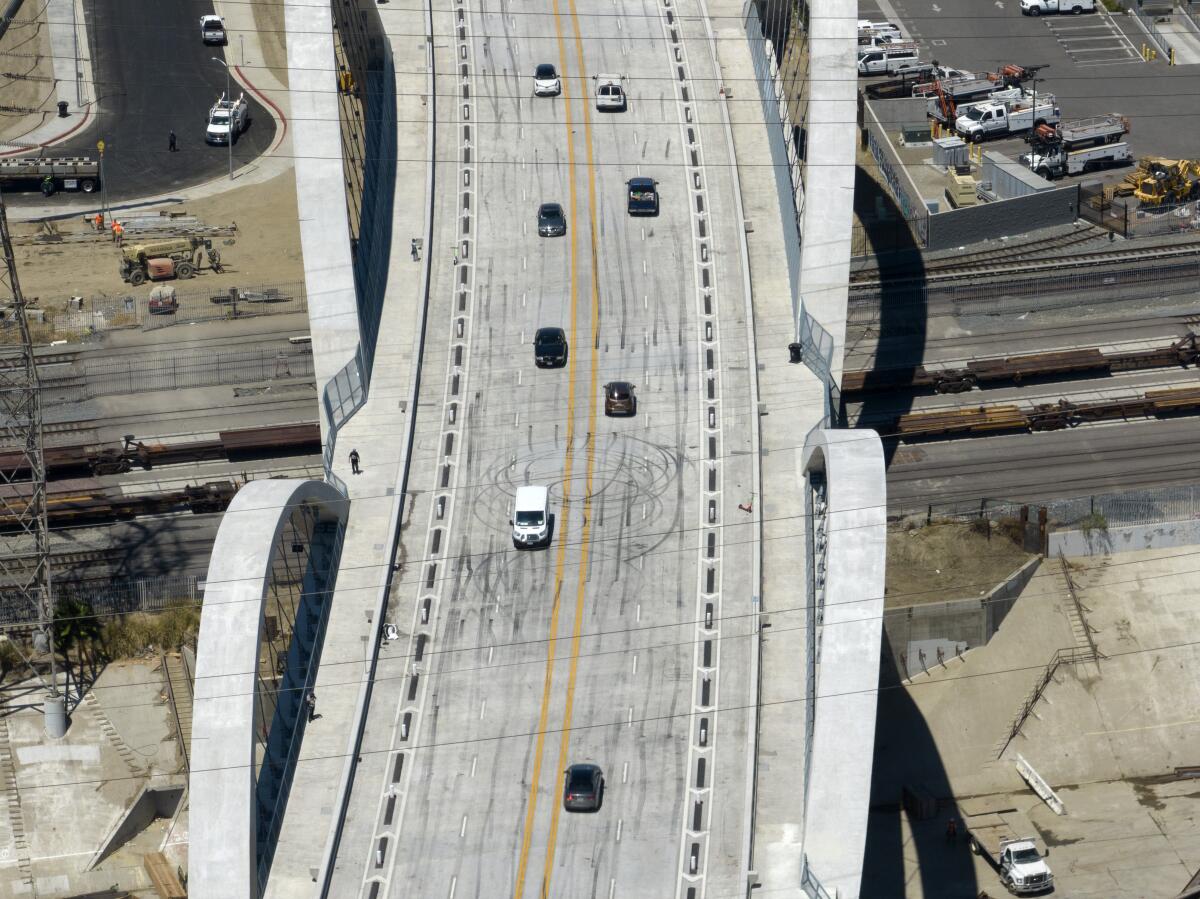 Cars travel on a bridge.