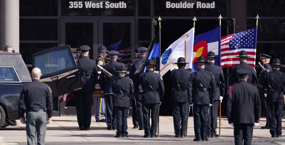 The honor guard unloads the casket to carry into a memorial service for fallen Police Department officer Eric Talley.