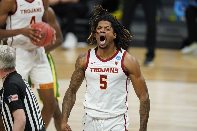 Southern California guard Isaiah White celebrates after making a basket during the first half of a Sweet 16.