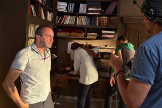 Director Al-Layth Hajjo, left, and actor Haima Ismail prepare for a scene in "Al-Batal."