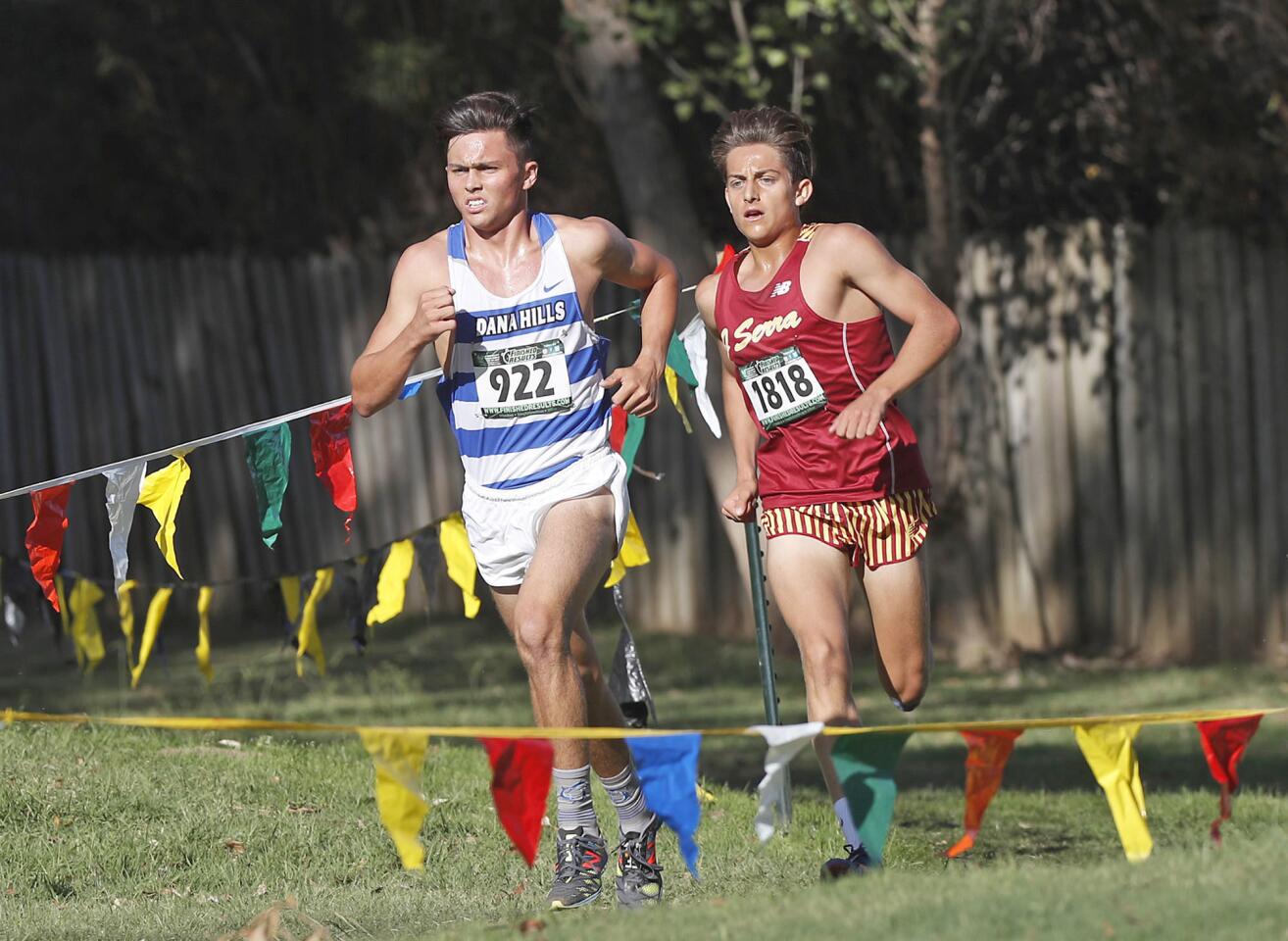Dana Hills Jack Landgraf, left, and J Serra's Anthony Grover race along in the Boys Sweepstakes race in the Orange County Cross Country Championships at Oak Canyon Park on Saturday.