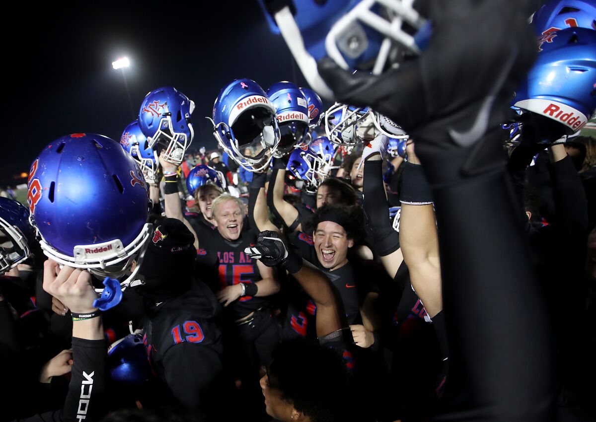 LONG BEACH, CALIF. - NOV. 11, 2022. The Los Alamitos Griffins football team celebrates.