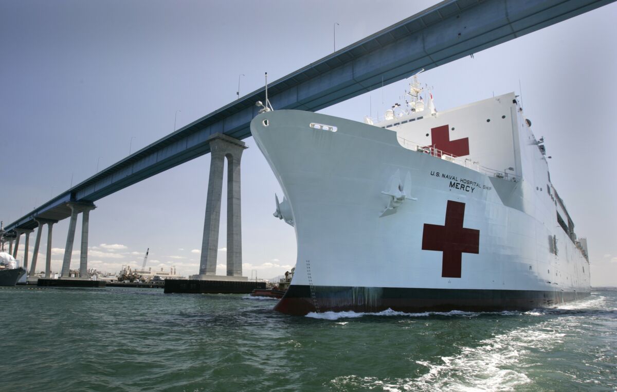 The U.S. Navy hospital ship Mercy steams beneath the Coronado Bridge shortly after setting sail from Naval Base San Diego.