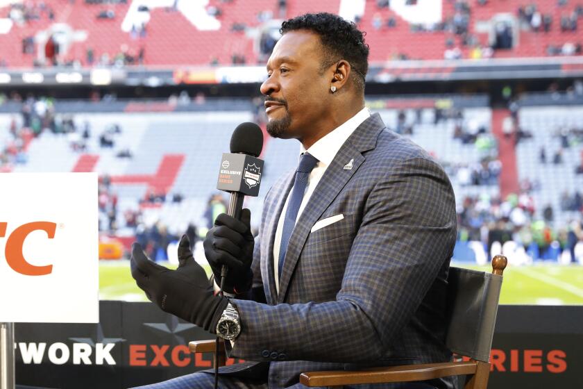 NFL Network's Willie McGinest reports from the sideline before an NFL football game between the Tampa Bay Buccaneers and the Seattle Seahawks at Allianz Arena in Munich, Germany, Sunday, Nov. 13, 2022. The Tampa Bay Buccaneers defeated the Seattle Seahawks 21-16. (AP Photo/Steve Luciano)