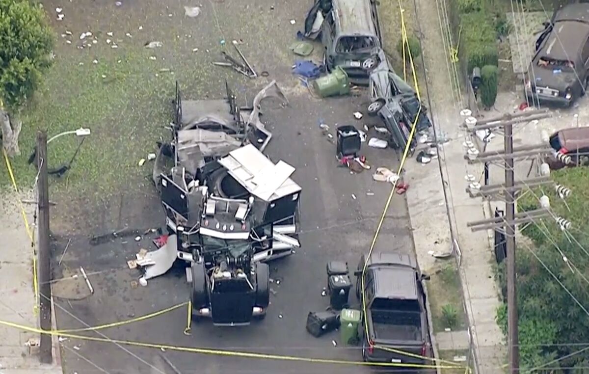 Aerial view of the remains of a destroyed armored truck, damaged vehicles and other debris scattered by explosion