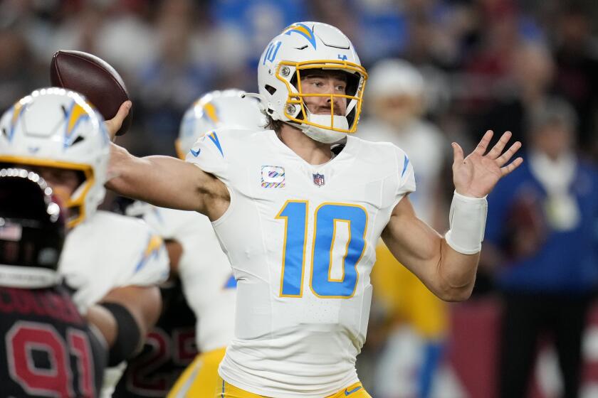 Los Angeles Chargers quarterback Justin Herbert (10) throws a pass during the first half.