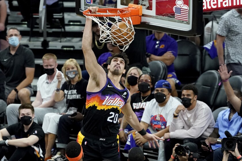Phoenix Suns forward Dario Saric (20) dunks against the Denver Nuggets during the first half of Game 2 of an NBA basketball second-round playoff series, Wednesday, June 9, 2021, in Phoenix. (AP Photo/Matt York)