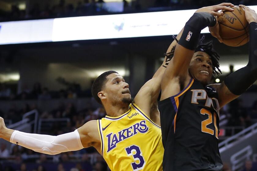 Los Angeles Lakers guard Josh Hart (3) blocks the shot on Phoenix Suns forward Richaun Holmes during the second half of an NBA basketball game Saturday, March 2, 2019, in Phoenix. The Suns defeated the Lakers 118-109.(AP Photo/Rick Scuteri)