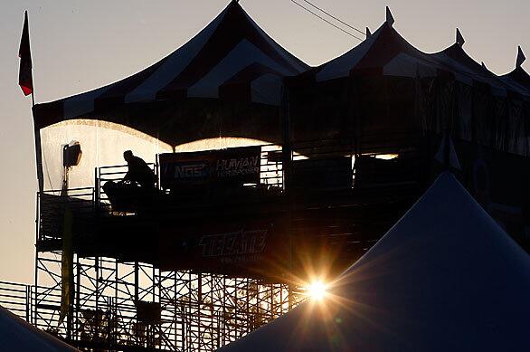 A race official sets up on a platform as a warm day dawns over the course of the 35th annual Grand Prix of Long Beach.