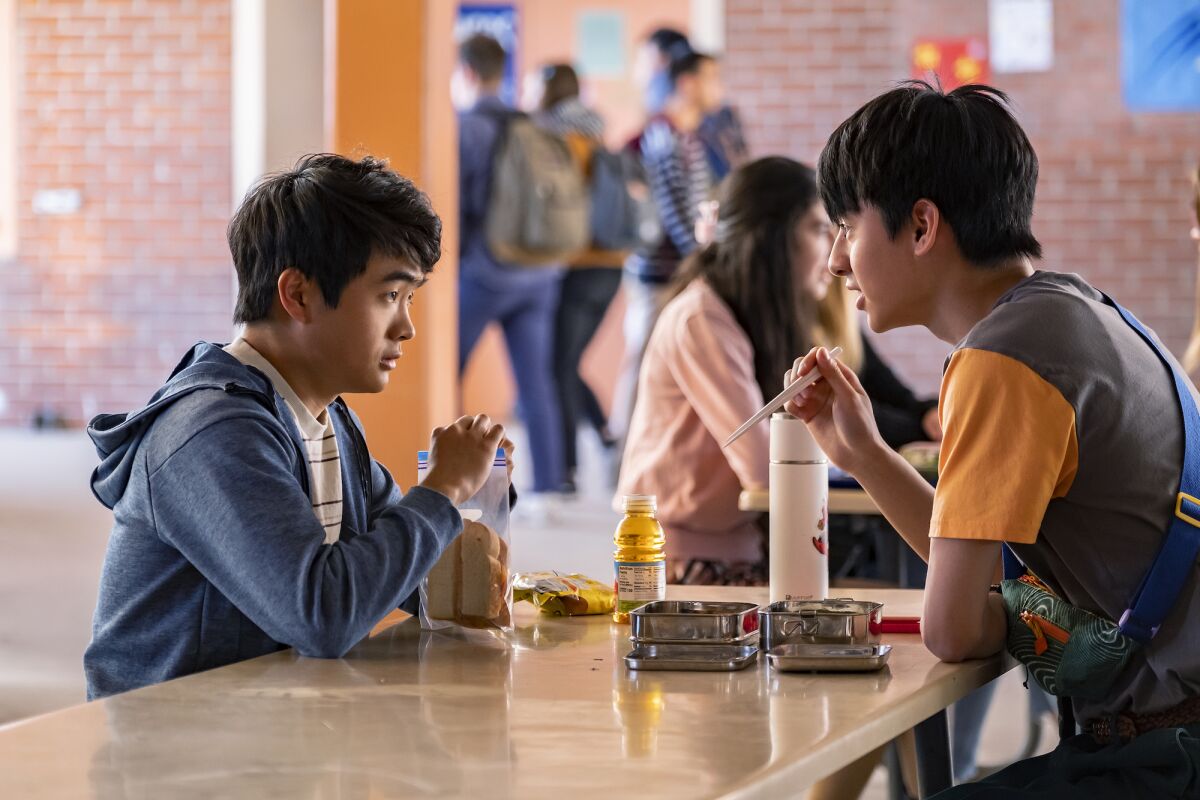Ben Wang and Jim Liu sitting at a school lunch table