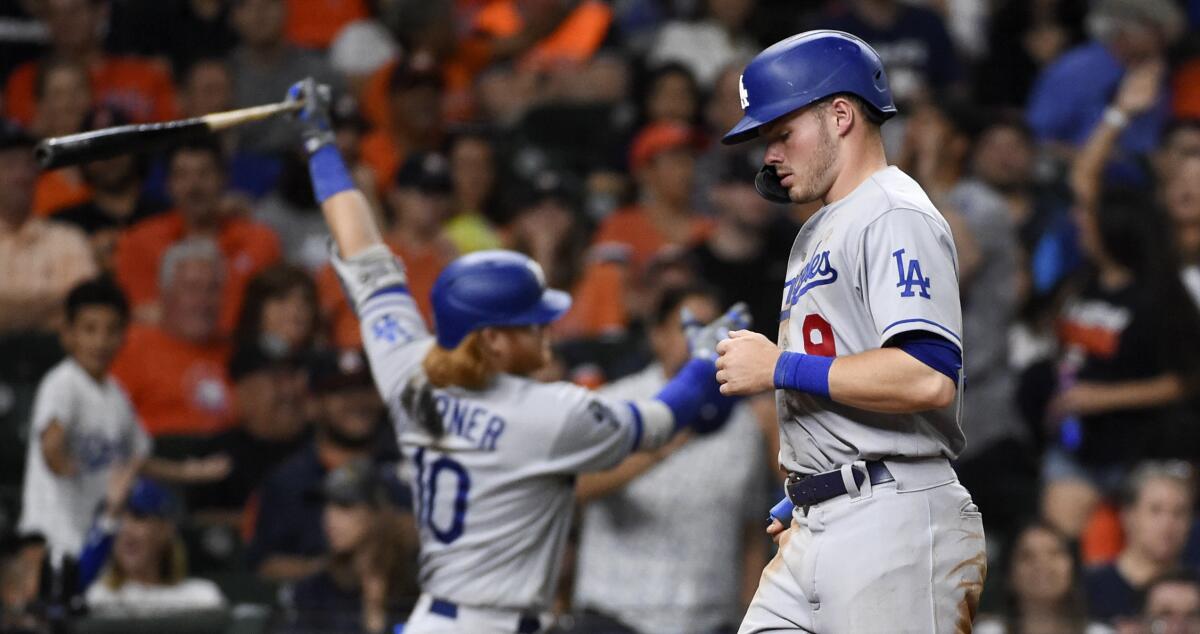 Los Angeles Dodgers' Gavin Lux, right, scores a run after Mookie Betts walked with the bases loaded.