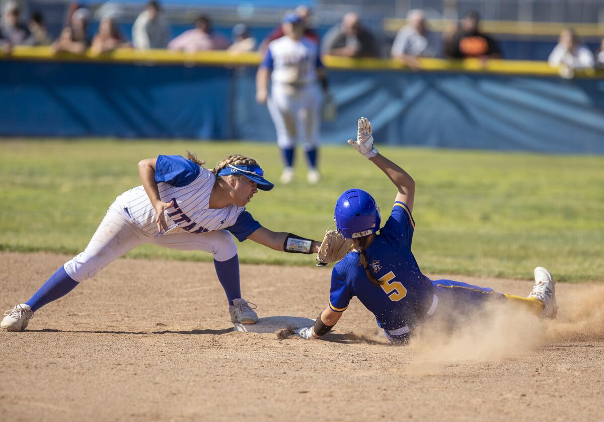 Fountain Valley's Taylor Reynolds hook slides under the tag from San Marino's Kate Brunner in the fourth inning on Thursday.