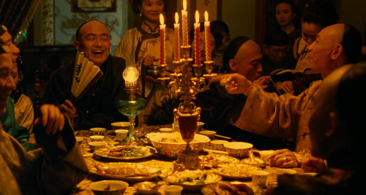 People laugh in a dinner scene from "Flowers of Shanghai."