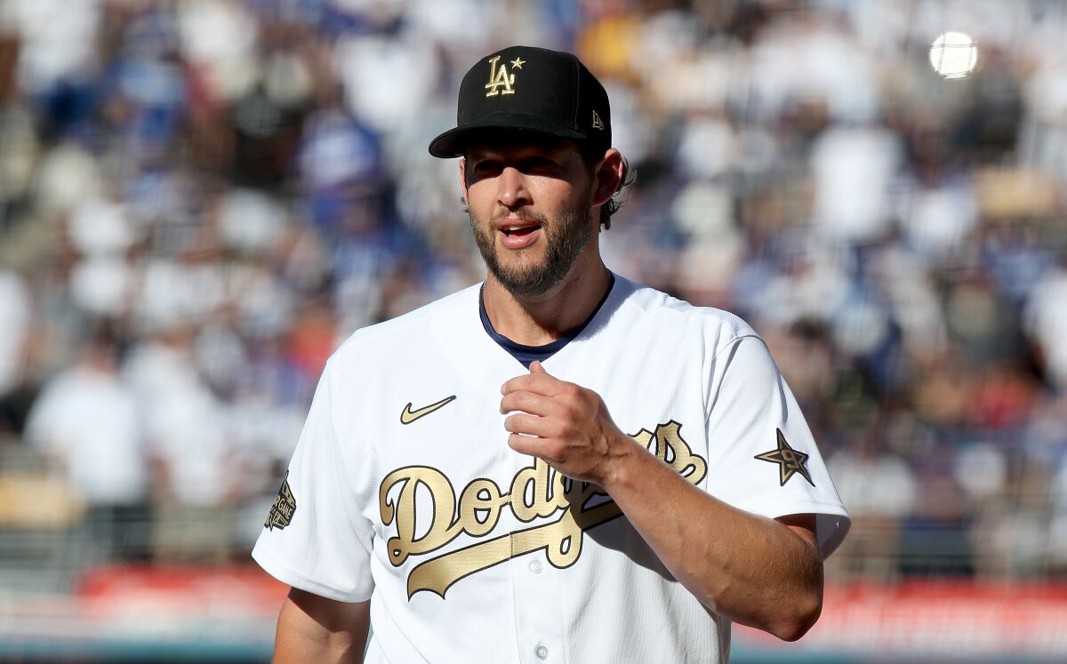 Clayton Kershaw wears a white and gold Dodgers jersey at the All-Star game.