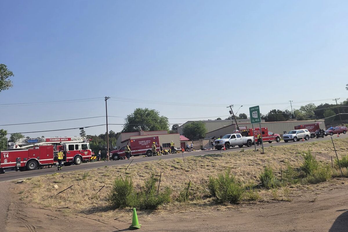 FILE - In this June 19, 2021, file photo, released by the Timber Mesa Fire and Medical District, emergency personnel gather at the scene of a mass casualty incident near Downtown 9 in Show Low, Ariz. A cyclist has died after he was struck by an Arizona driver who plowed his pickup truck into a group of people participating in a bike race, authorities said. A 58-year-old man died of his injuries Saturday, July 10 Arizona Department of Public Safety spokesman Bart Graves said Monday, July 12. No other information about the victim was immediately released. The accused driver, Shawn Michael Chock, was indicted last week on aggravated assault with a deadly weapon and other charges. (Timber Mesa Fire and Medical District via AP, File)