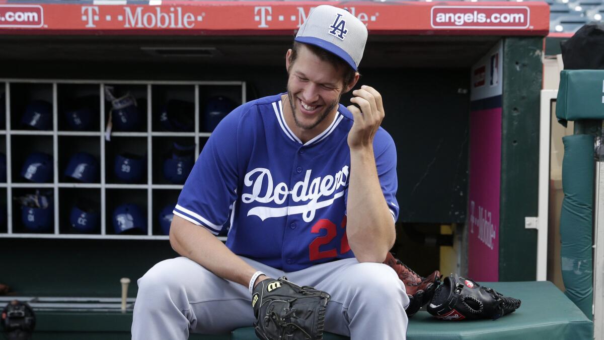 Dodgers pitcher Clayton Kershaw smiles while talking with his teammates before an exhibition game against the Angels on Friday.