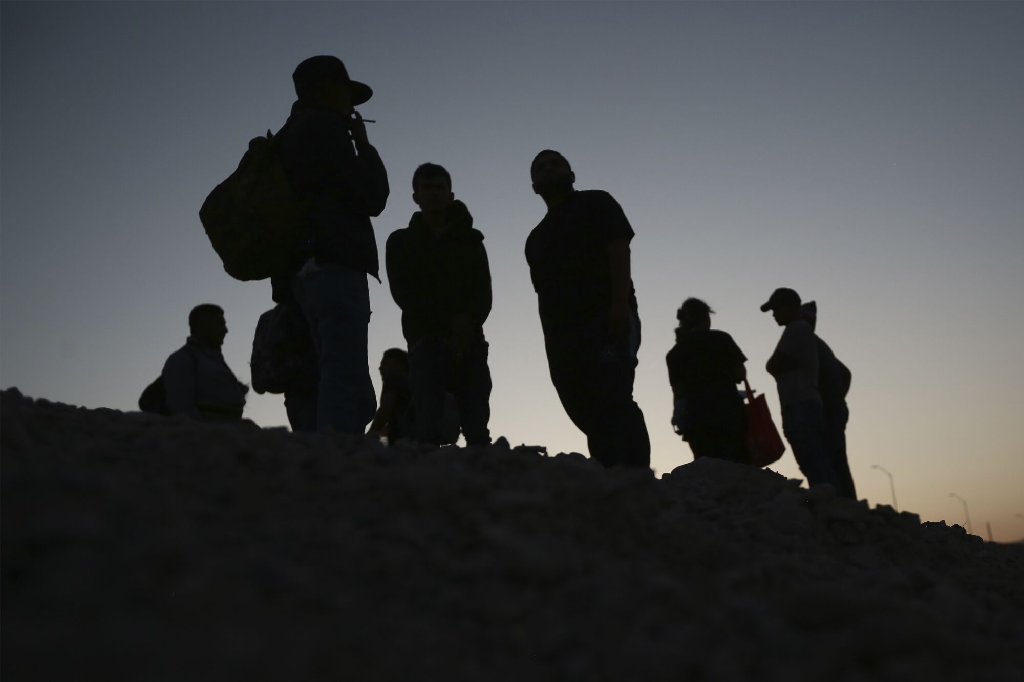 Migrants wait for U.S. authorities.