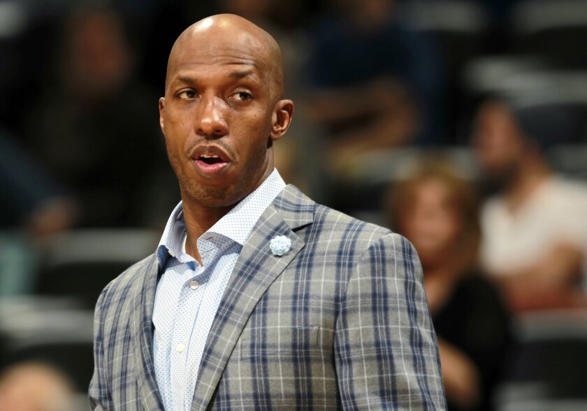Chauncey Billups watches an NBA game from the sideline.