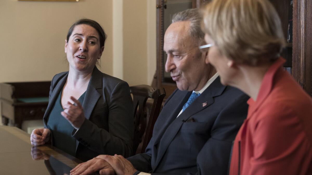 Leandra English, left, the deputy director of the Consumer Financial Protection Bureau, meets with Senate Democratic leader Charles E. Schumer (D-N.Y.) and Sen. Elizabeth Warren (D-Mass.) in November.