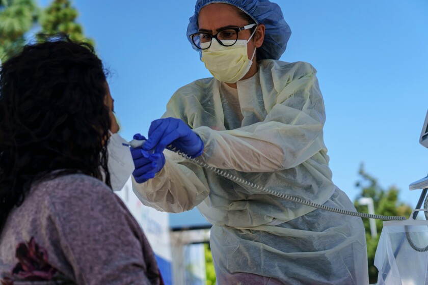 Angela Francois takes a patient's temperature at a Chula Vista hospital.