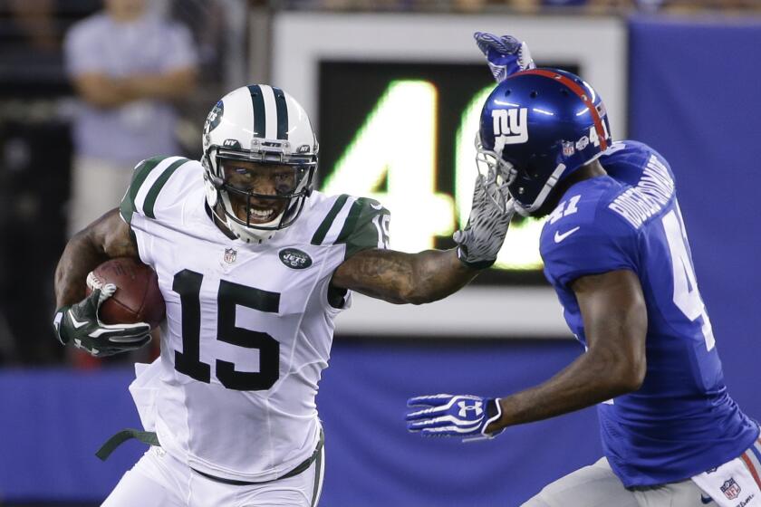 Brandon Marshall (15) tries to fend off Giants defensive back Dominique Rodgers-Cromartie while playing for the Jets.
