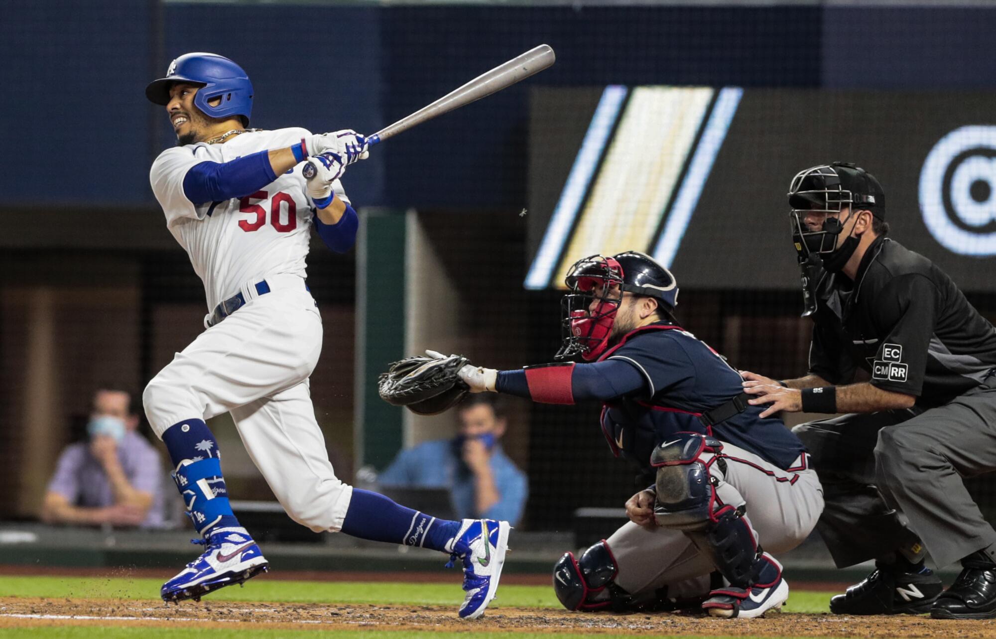 Dodgers right fielder Mookie Betts lines out to center field during the third inning in Game 1 of the NLCS.