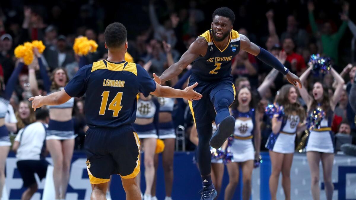 UC Irvine's Evan Leonard, left, celebrates a three-point shot with teammate Max Hazzard during the Anteaters' victory over Kansas State in the first round of the NCAA tournament on Friday.