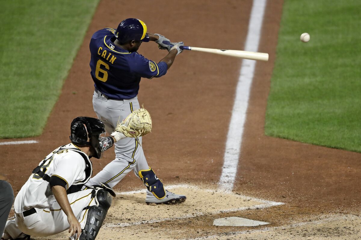 Milwaukee Brewers' Lorenzo Cain drives in a run with a single off Pittsburgh Pirates relief pitcher Nik Turley during the seventh inning of a baseball game in Pittsburgh, Monday, July 27, 2020. (AP Photo/Gene J. Puskar)