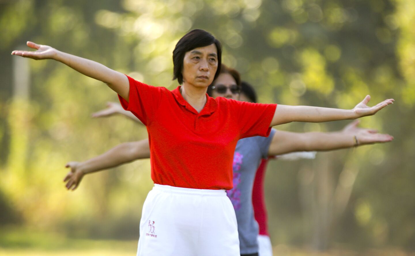 To beat the heat, Lily Lin leads an early morning Tai Chi class at Vincent Lugo Park in San Gabriel.