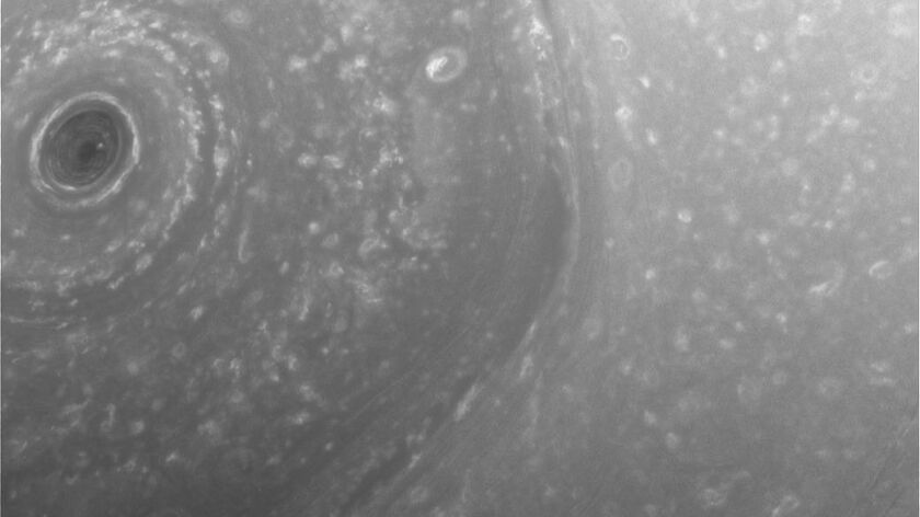 NASA's Cassini spacecraft took this image about half a day before its first close pass by the outer edges of Saturn's main rings. The view shows part of the giant, hexagon-shaped jet stream around the planet's north pole and a smaller circular storm just above the pole, left.