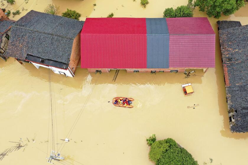 FILE - Rescuers use a dinghy boat to evacuate villagers trapped by floodwaters in Jingtang village, Zixing city, in southern China's Hunan province, on July 28, 2024. (Chinatopix via AP, File)