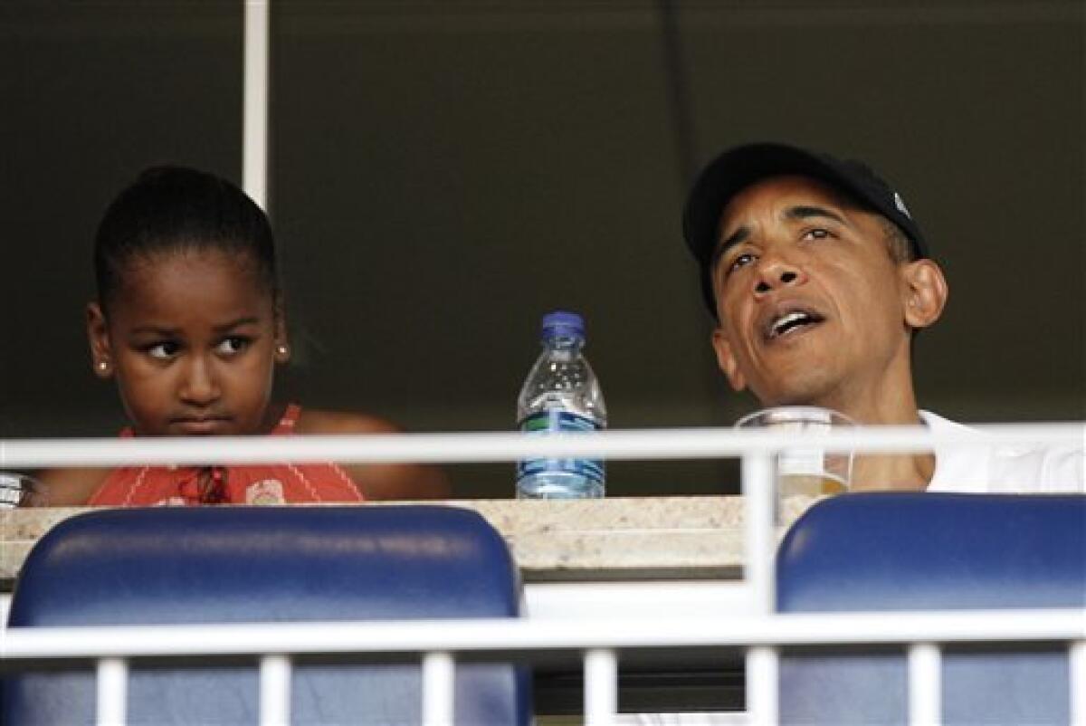 President Barack Obama, right, with his daughter Sasha, left, attend an interleague baseball game between Chicago White Sox, Friday, June 18, 2010 in Washington. (AP Photo/Pablo Martinez Monsivais)
