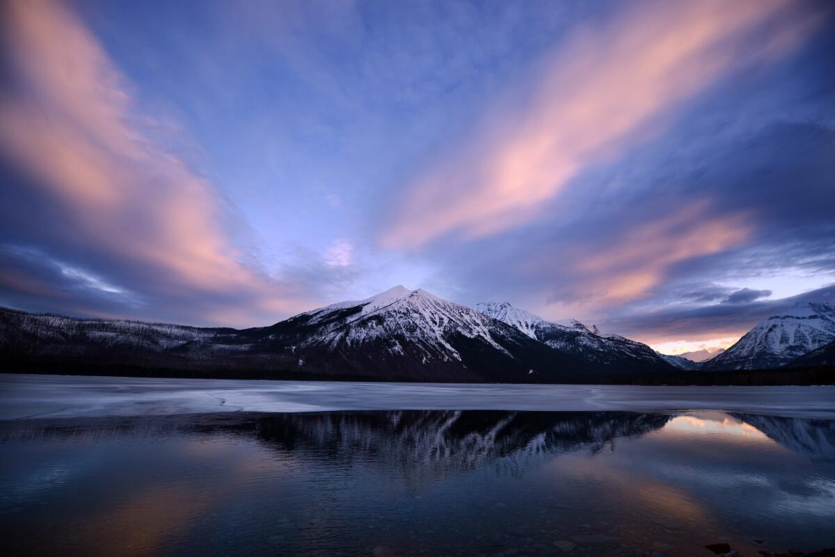 A snowy sunrise over Lake McDonald in Glacier National Park in Montana.