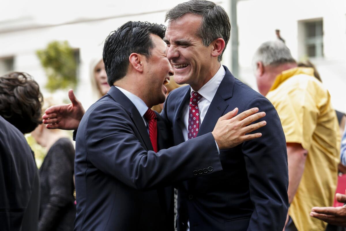 David Ryu hugs Los Angeles Mayor Eric Garcetti after he is sworn in as a city councilman on the steps of City Hall in 2015.