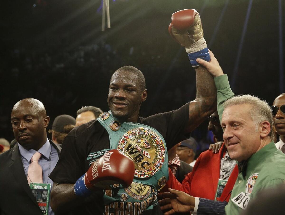 Deontay Wilder holds up his arm after he defeated Eric Molina during the WBC heavyweight boxing match June 13 in Birmingham, Ala.