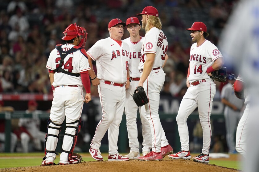 Angels interim manager Phil Nevin talks with starting pitcher Noah Syndergaard on the mound.