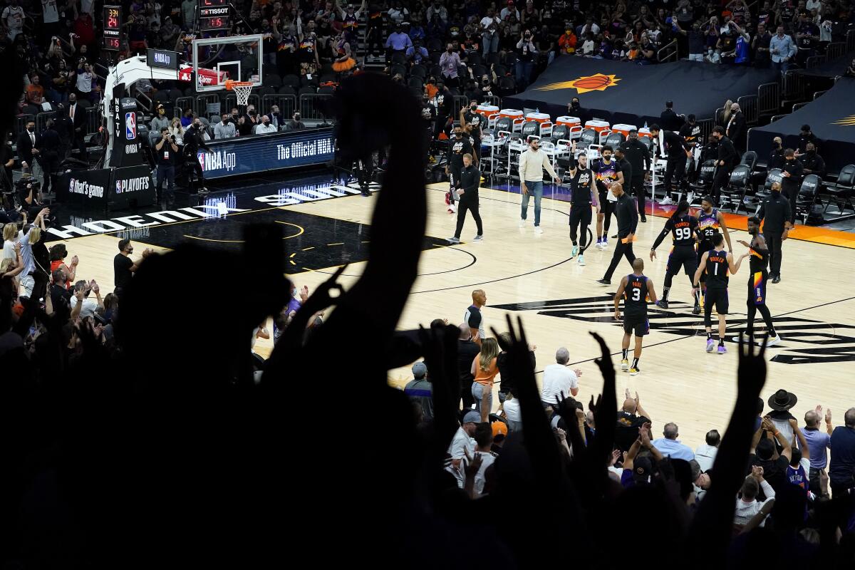Phoenix Suns fans cheer during the second half of Game 1 of an NBA basketball second-round playoff series abasing the Denver Nuggets, Monday, June 7, 2021, in Phoenix. (AP Photo/Matt York)