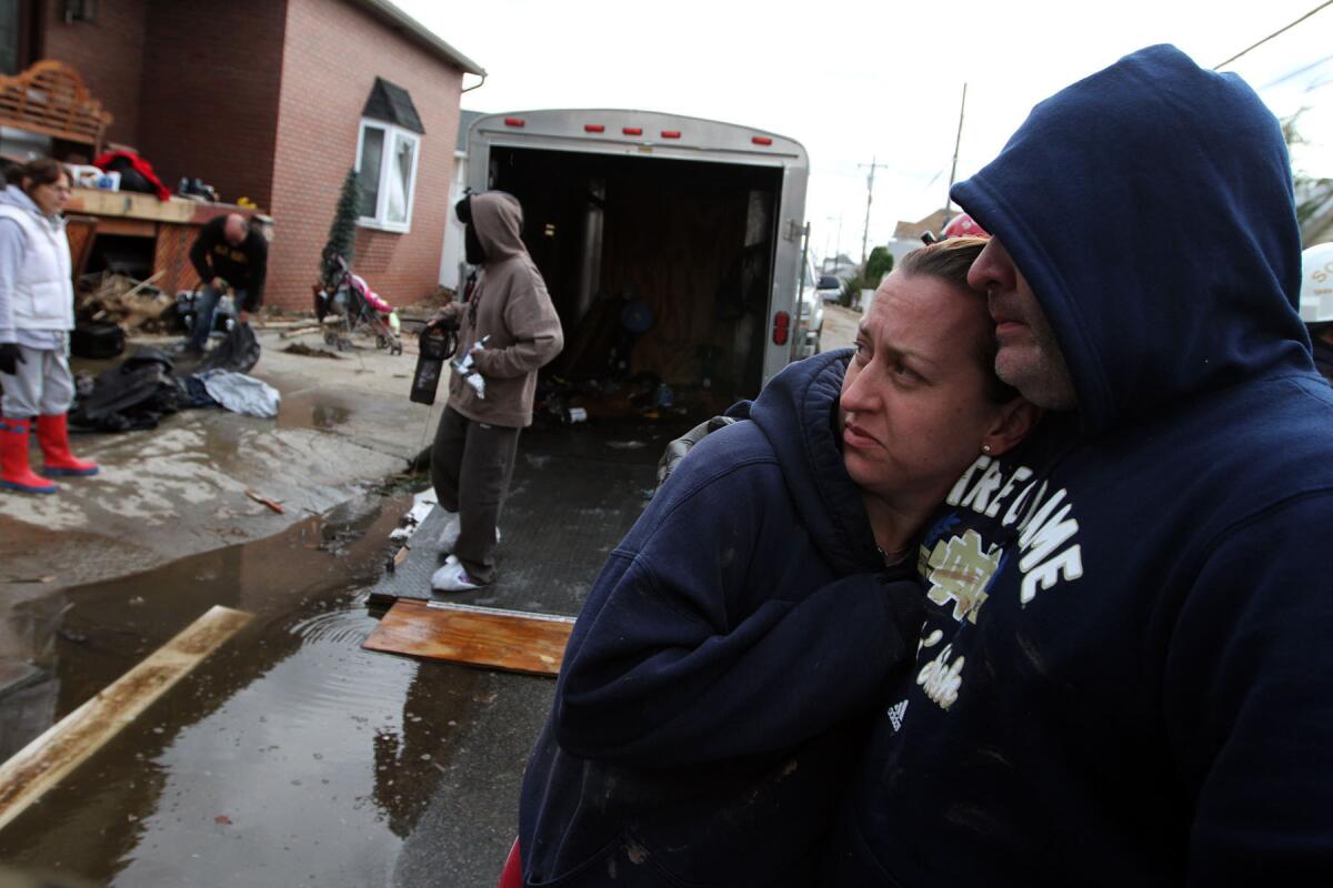 Hilary and James Bowden embrace while helping James' brother with his destroyed home on Staten Island.