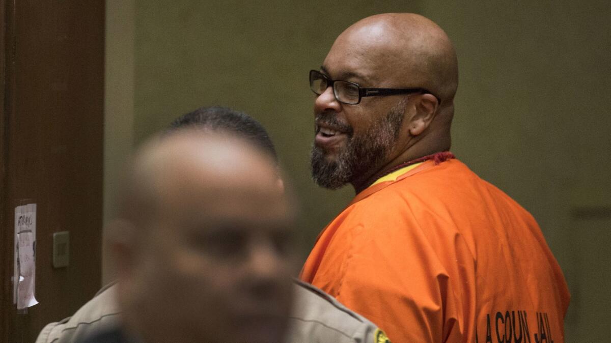 Suge Knight smiles at friends and family members in the courtroom.
