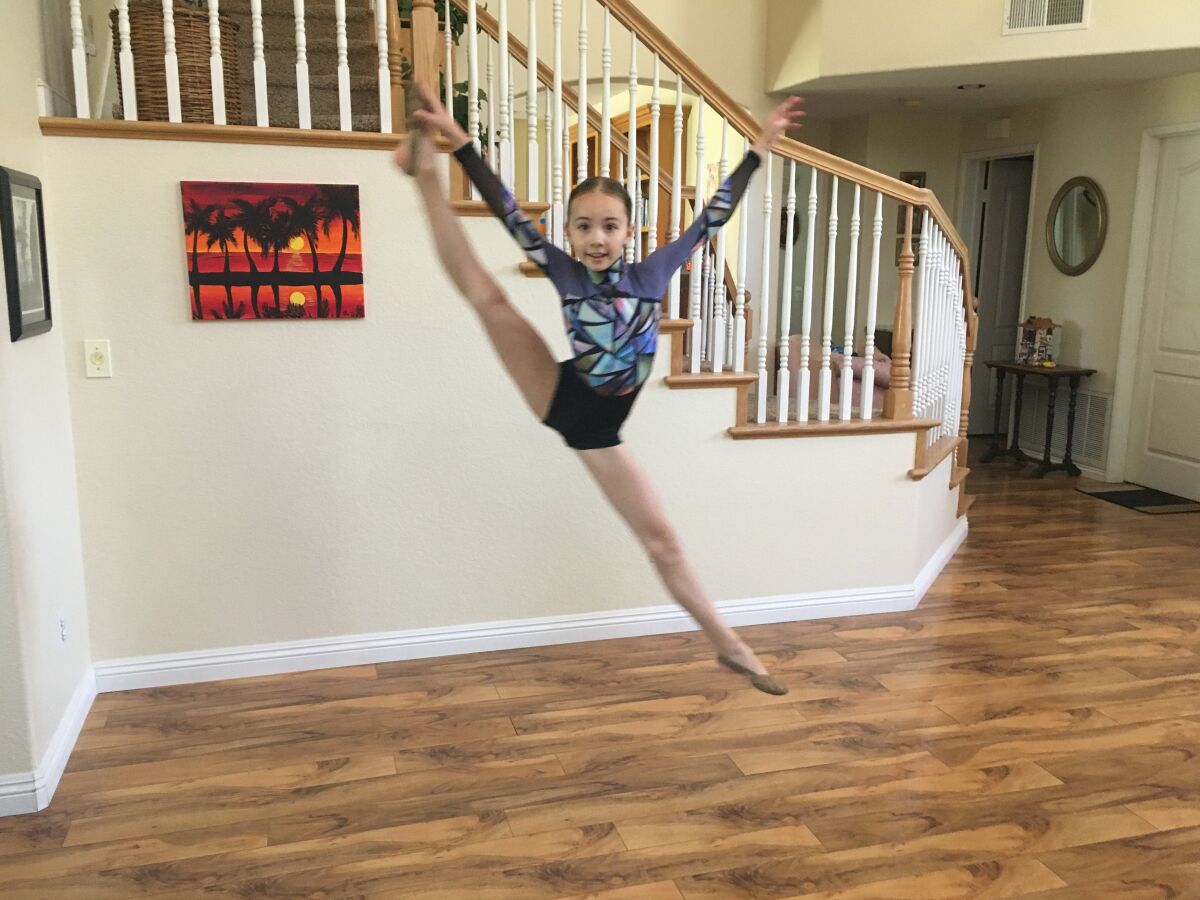 Fourth grader Karolina danced in her home.