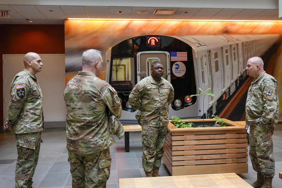 National Guard members wait in the lobby of the New York City Mass Transit Authority Rail Control Center.