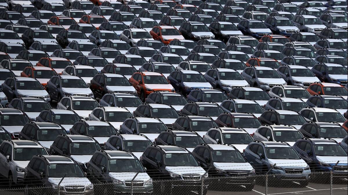 Brand new cars sit in a lot at the Auto Warehousing Company near the Port of Richmond on May 24.