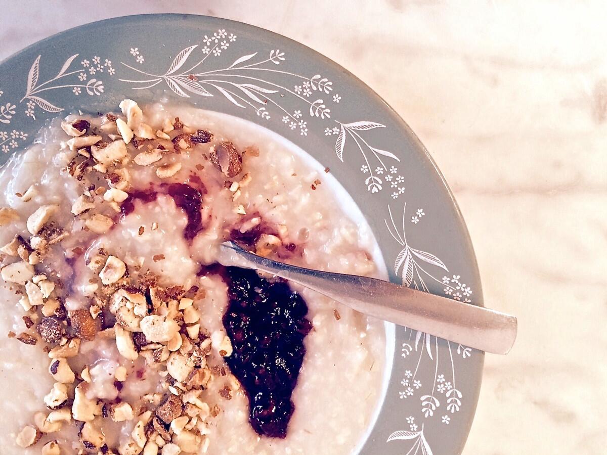 A bowl of brown rice porridge, with hazelnuts, almond milk and blackberry-Meyer lemon jam, at Sqirl.