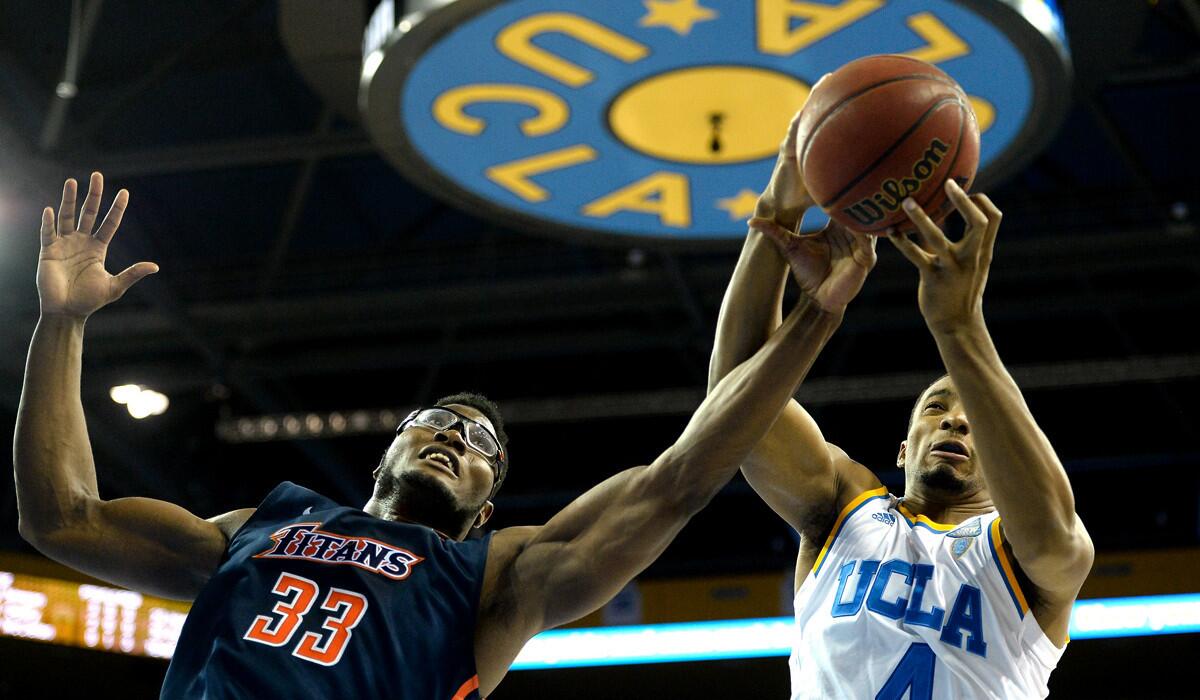 UCLA guard Norman Powell grabs a rebound against Cal State Fullerton's Kennedy Esume in the first half Wednesday night.