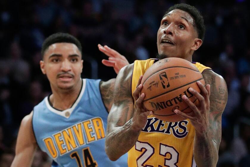 Lakers' Lou Williams drives to the basket past Denver's Gary Harris on Jan. 31 at Staples Center.