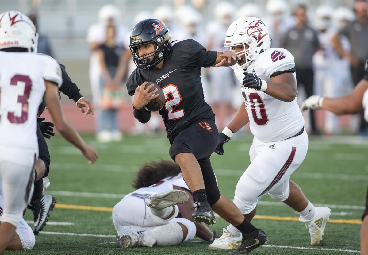 Los Amigos quarterback Maysen Navarro keeps the ball on a two-point conversion attempt against Ocean View.