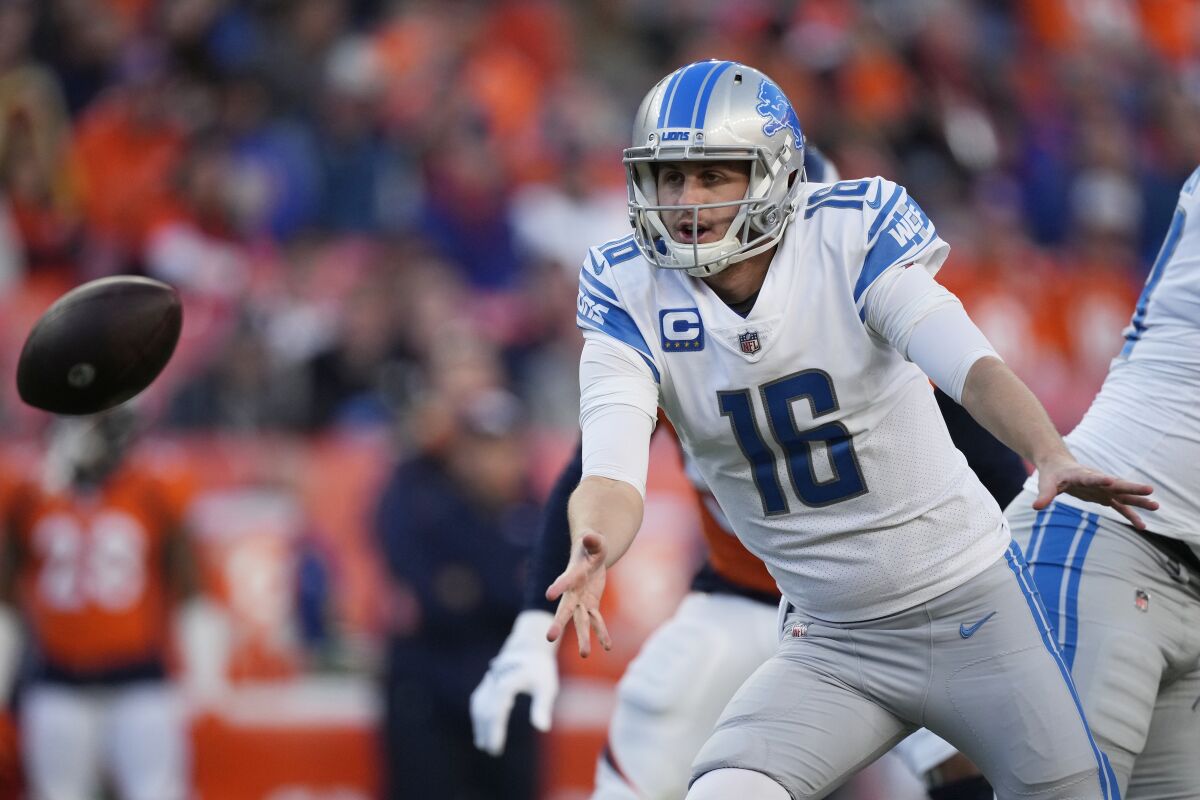 Detroit Lions quarterback Jared Goff (16) tosses the ball during the second half of an NFL football game against the Denver Broncos, Sunday, Dec. 12, 2021, in Denver. (AP Photo/David Zalubowski)