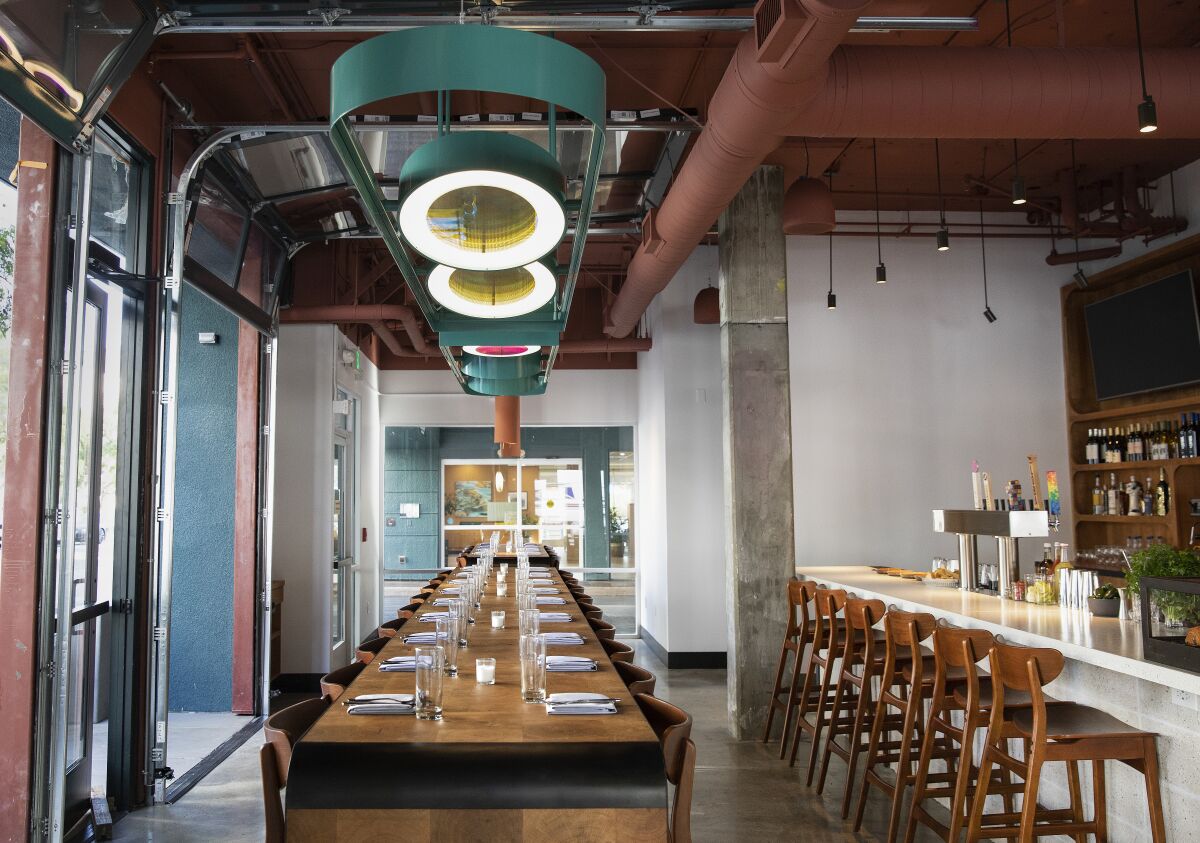 A cherry wood long communal table is located near the bar inside of Socalo, the new restaurant from Susan Feniger and Mary Sue Milliken in Santa Monica.