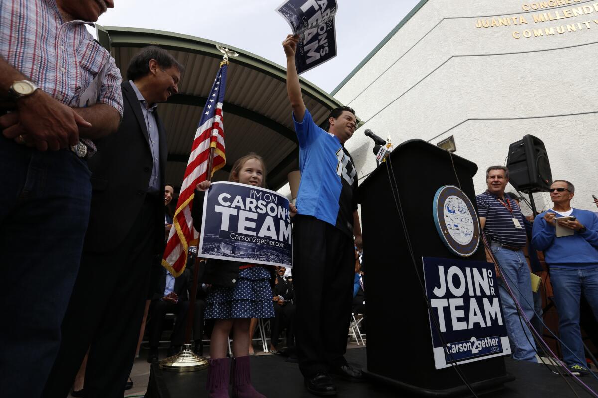 Wearing a half-Chargers, half-Raiders jersey, Albert Robles speaks during a Feb. 20, 2015, news conference that officially announced a plan to build an NFL stadium in Carson.