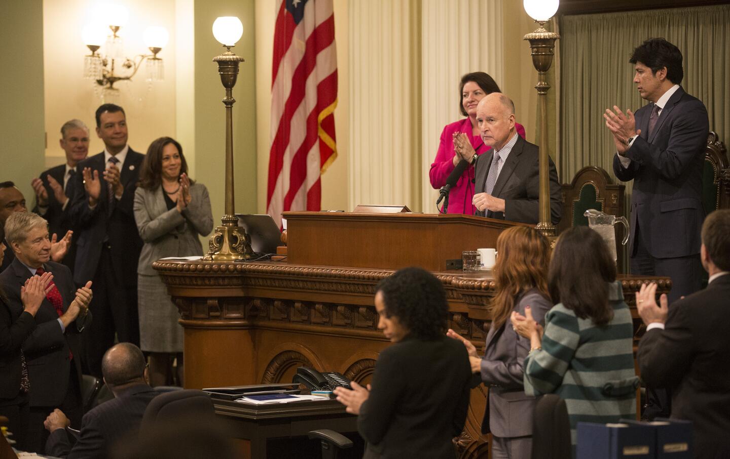 Gov. Edmund G. Brown Jr. is applauded before delivering his State of the State address before a joint session of the Legislature in Sacramento.